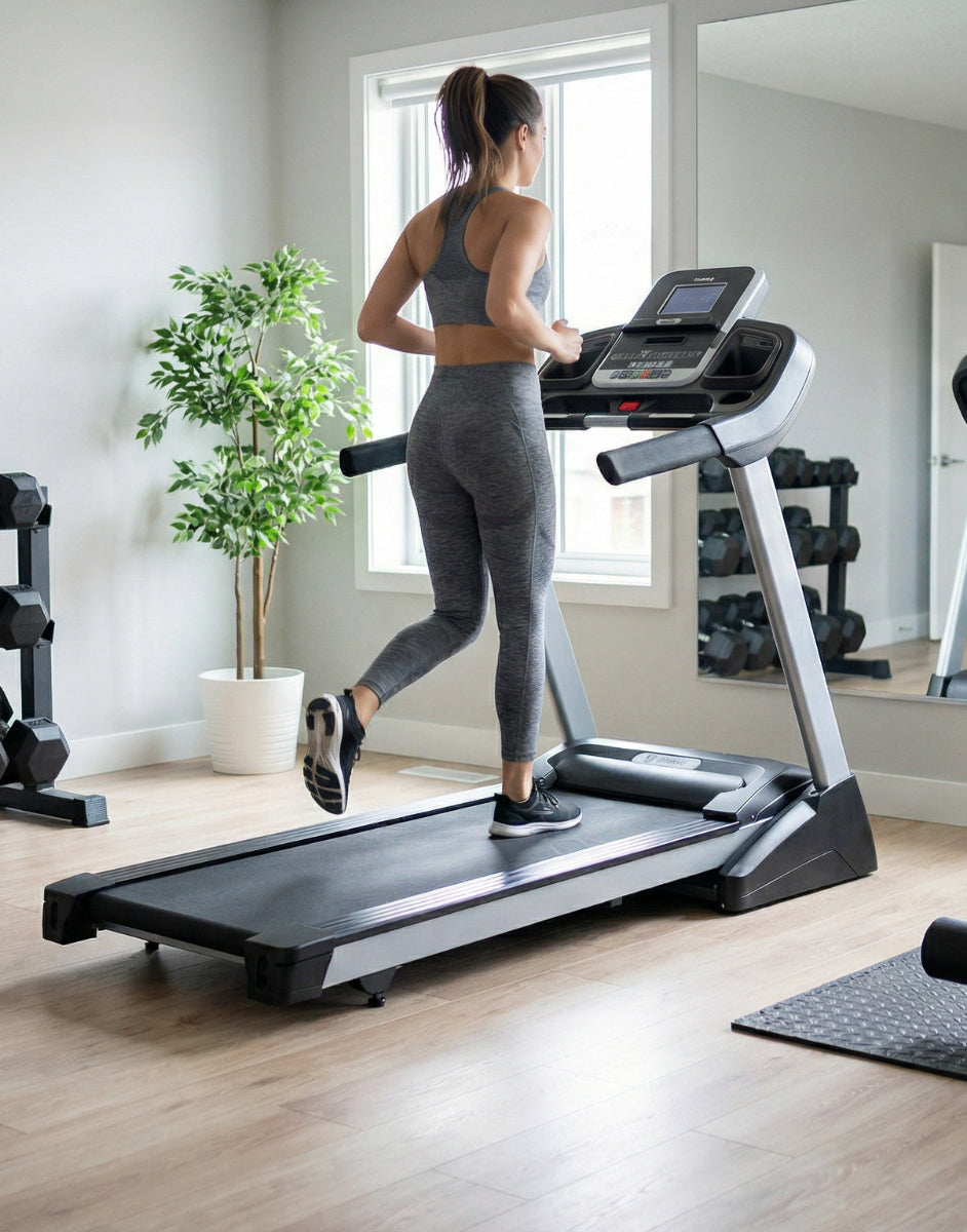Woman exercising on a treadmill in a home gym setting