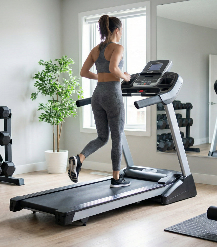 Woman exercising on a treadmill in a home gym setting